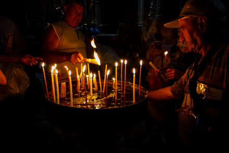 Jerusalem Israel May 16, 2018 Unknowns pilgrims praying and lighting candles in the Church of the Holy Sepulchre at the old city of Jerusalem in the eveningのeditorial素材