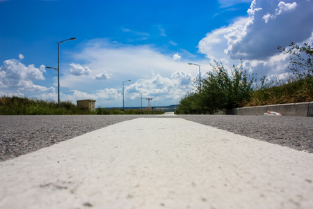 View of a road and landscape with a cloudy sky around Reims in France