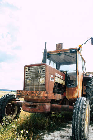 Bezannes France july 07, 2018 View of a tractor working in the field in Champagne area in the afternoonのeditorial素材