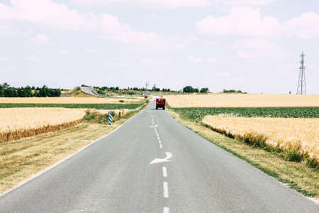 Bezannes France july 07, 2018 View of a tractor working in the field in Champagne area in the afternoonのeditorial素材