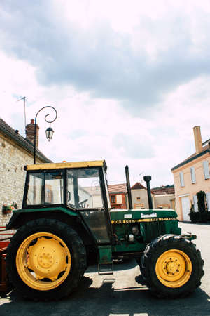 Bezannes France july 07, 2018 View of a tractor working in the field in Champagne area in the afternoonのeditorial素材