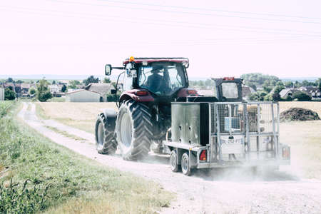 Bezannes France july 07, 2018 View of a tractor working in the field in Champagne area in the...