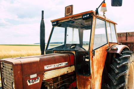 Bezannes France july 07, 2018 View of a tractor working in the field in Champagne area in the...