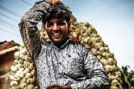 Gokarna Karnataka India November 01, 2017 Portrait of unknown people selling flowers in the street of Gokarna town in the eveningのeditorial素材
