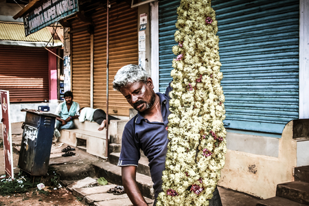 Gokarna Karnataka India November 01, 2017 Portrait of unknown people selling flowers in the street of Gokarna town in the eveningのeditorial素材