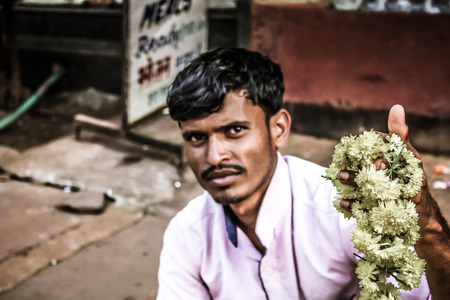 Gokarna Karnataka India November 01, 2017 Portrait of unknown people selling flowers in the street of Gokarna town in the eveningのeditorial素材
