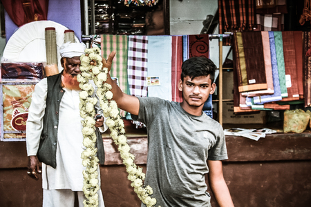 Gokarna Karnataka India November 01, 2017 Portrait of unknown people selling flowers in the street of Gokarna town in the eveningのeditorial素材