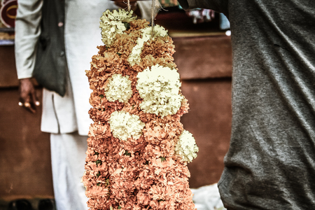 Gokarna Karnataka India November 01, 2017 Portrait of unknown people selling flowers in the street of Gokarna town in the eveningのeditorial素材