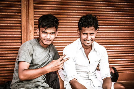 Gokarna Karnataka India November 01, 2017 Portrait of unknown people selling flowers in the street of Gokarna town in the eveningのeditorial素材