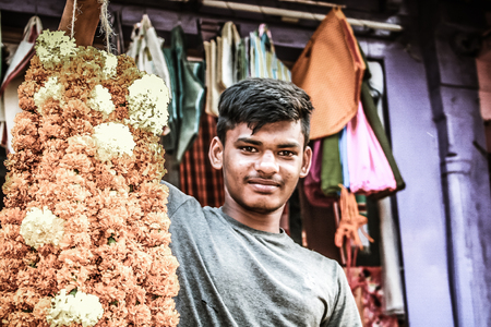 Gokarna Karnataka India November 01, 2017 Portrait of unknown people selling flowers in the street of Gokarna town in the eveningのeditorial素材