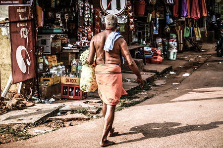 Gokarna Karnataka India November 01, 2017 Portrait of unknown people selling flowers in the street of Gokarna town in the eveningのeditorial素材