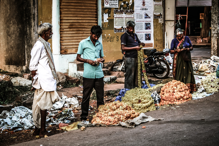 Gokarna Karnataka India November 01, 2017 Portrait of unknown people selling flowers in the street of Gokarna town in the eveningのeditorial素材
