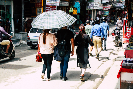 Kathmandu Nepal August 21, 2018 View of unknown people walking with a umbrella in Thamel street in...