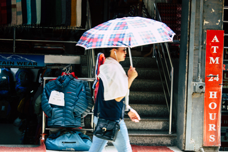 Kathmandu Nepal August 21, 2018 View of unknown people walking with a umbrella in Thamel street in Kathmandu in the morningのeditorial素材