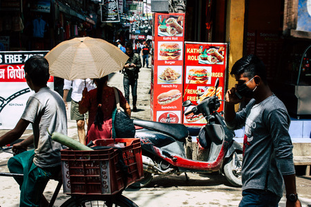 Kathmandu Nepal August 21, 2018 View of unknown people walking with a umbrella in Thamel street in...