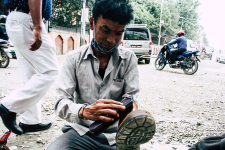 Kathmandu Nepal August 22, 2018 Closeup of a Nepali shoe polisher working  at Thamel street in Kathmandu in the morningのeditorial素材