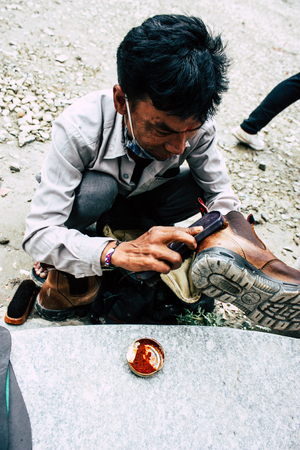 Kathmandu Nepal August 22, 2018 Closeup of a Nepali shoe polisher working  at Thamel street in Kathmandu in the morningのeditorial素材