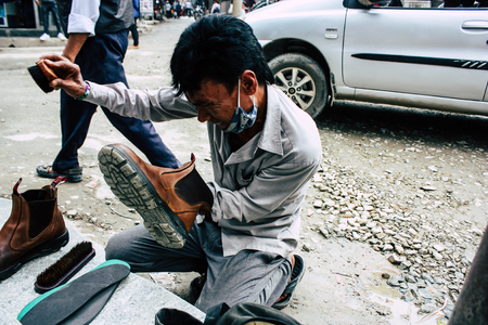 Kathmandu Nepal August 22, 2018 Closeup of a Nepali shoe polisher working  at Thamel street in Kathmandu in the morningのeditorial素材