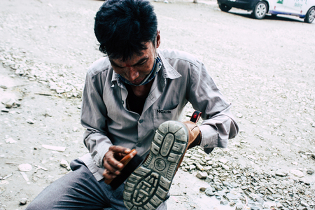 Kathmandu Nepal August 22, 2018 Closeup of a Nepali shoe polisher working  at Thamel street in Kathmandu in the morningのeditorial素材
