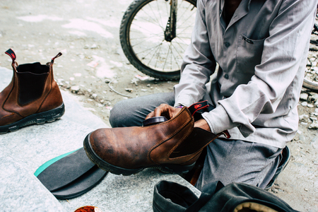 Kathmandu Nepal August 22, 2018 Closeup of a Nepali shoe polisher working  at Thamel street in Kathmandu in the morningのeditorial素材
