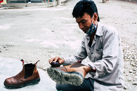 Kathmandu Nepal August 22, 2018 Closeup of a Nepali shoe polisher working  at Thamel street in Kathmandu in the morningのeditorial素材