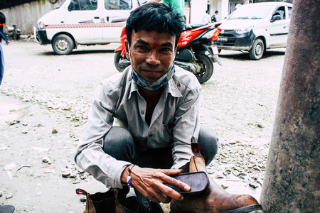 Kathmandu Nepal August 22, 2018 Closeup of a Nepali shoe polisher working  at Thamel street in Kathmandu in the morningのeditorial素材