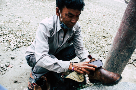Kathmandu Nepal August 22, 2018 Closeup of a Nepali shoe polisher working  at Thamel street in Kathmandu in the morningのeditorial素材
