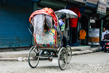 Kathmandu Nepal August 22, 2018 View of unknown Nepali people driving a touk touk in Thamel street in Kathmandu in the morningのeditorial素材