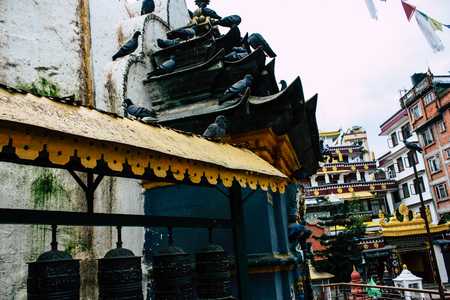 Kathmandu Nepal August 24, 2018 View of pigeons flying around the Shree Gha Stupa Temple located in Naghal district between Thamel and Durbar square in Kathmandu in the morningのeditorial素材