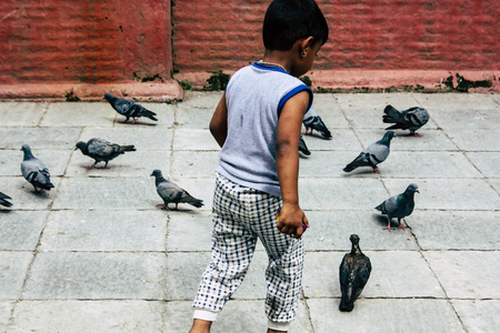 Kathmandu Nepal August 24, 2018 View of a Nepali child playing around the Shree Gha Stupa Temple located in Naghal district between Thamel and Durbar square in Kathmandu in the morningのeditorial素材