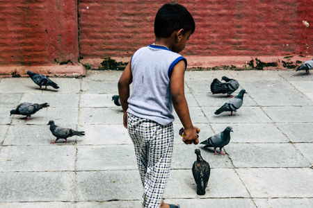 Kathmandu Nepal August 24, 2018 View of a Nepali child playing around the Shree Gha Stupa Temple located in Naghal district between Thamel and Durbar square in Kathmandu in the morningのeditorial素材