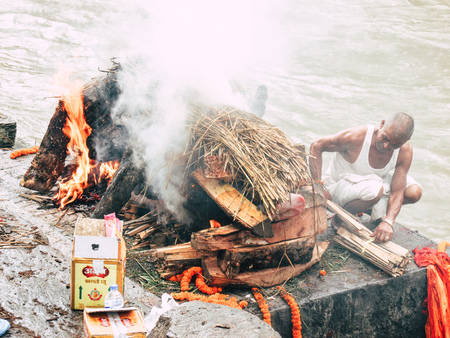 Kathmandu Nepal August 27, 2018 Hindu people attending a religious ceremony, the cremation of a dead body front the river at the Pashupatinath temple in the afternoonのeditorial素材
