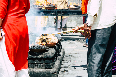 Kathmandu Nepal August 27, 2018 View of unknowns Hindu people making the fire ceremony inside the Pashupatinath temple in the morningのeditorial素材