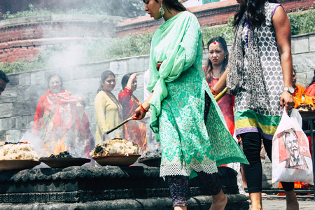 Kathmandu Nepal August 27, 2018 View of unknowns Hindu people making the fire ceremony inside the Pashupatinath temple in the morningのeditorial素材