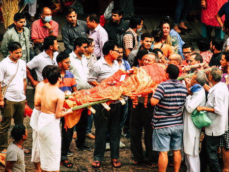Kathmandu Nepal August 27, 2018 Hindu people attending a religious ceremony, the cremation of a dead body front the river at the Pashupatinath temple in the afternoonのeditorial素材