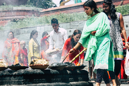 Kathmandu Nepal August 27, 2018 View of unknowns Hindu people making the fire ceremony inside the Pashupatinath temple in the morningのeditorial素材