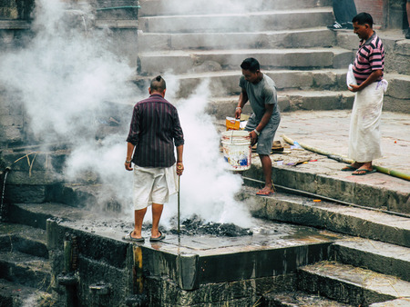 Kathmandu Nepal August 27, 2018 View of the cremation site of a dead body front the river at the temple of Pashupatinath in the afternoonのeditorial素材