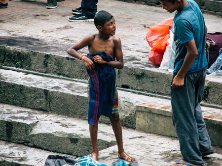 Kathmandu Nepal August 27, 2018 View of unknown Nepali taking a bath in the river at the cremation...