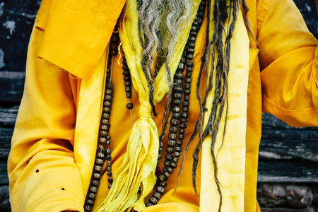 Kathmandu Nepal September 1, 2018 Portrait of a Sadhu with paint dots on the face and yellow clothes sitting at Durbar square in Kathmandu in the morningのeditorial素材