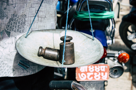 Kathmandu Nepal September 1, 2018 Closeup of a scale of a unknown Nepali people selling fruits at the street vegetable market in Chhetrapati square Kathmandu in the morningのeditorial素材