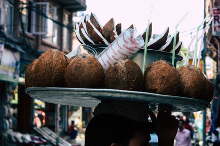 Kathmandu Nepal September 5, 2018 Closeup of a Nepalese street vendor working to sell coconuts in...