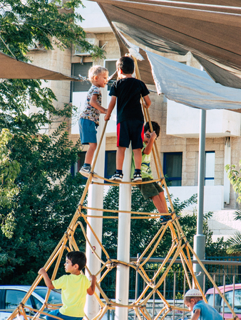 Jerusalem Israel September 11, 2018  View of Israeli kids playing with a bicycle in the street of Jerusalem in the afternoonのeditorial素材