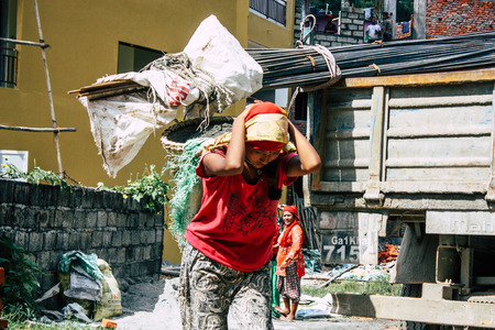 Pokhara Nepal September 23, 2018 Closeup of Nepalese porter carrying sand for construction of a new house in Pokara Lakeside in the afternoonのeditorial素材