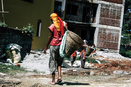 Pokhara Nepal September 23, 2018 Closeup of Nepalese porter carrying sand for construction of a new house in Pokara Lakeside in the afternoonのeditorial素材