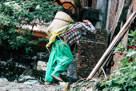 Pokhara Nepal September 23, 2018 Closeup of Nepalese porter carrying sand for construction of a new house in Pokara Lakeside in the afternoonのeditorial素材