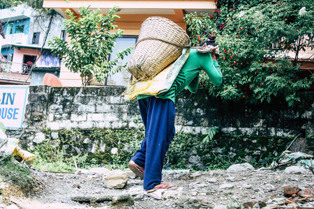 Pokhara Nepal September 23, 2018 Closeup of Nepalese porter carrying sand for construction of a new house in Pokara Lakeside in the afternoonのeditorial素材