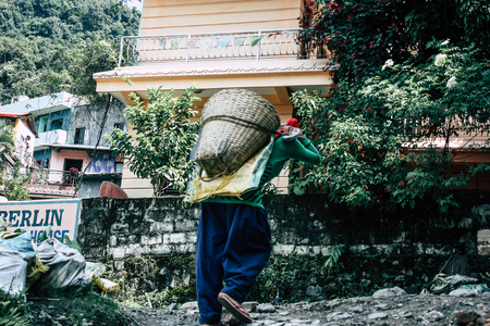 Pokhara Nepal September 23, 2018 Closeup of Nepalese porter carrying sand for construction of a new...