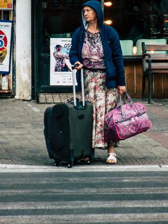 Tel Aviv Israel September 28, 2018 View of unknown Israeli womn with two bgs walking in the street in Tel Aviv in the afternoonのeditorial素材