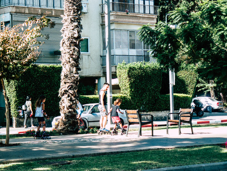 Tel Aviv Israel September 28, 2018 View of unknown Israeli people with two children in roller skates in the center of Tel Aviv in the morningのeditorial素材