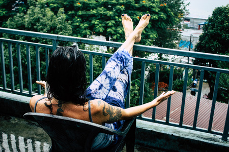 Pokhara Nepal October 2, 2018 Closeup of unknown female tourist standing under the rain in Pokhara Lakeside in the afternoonのeditorial素材